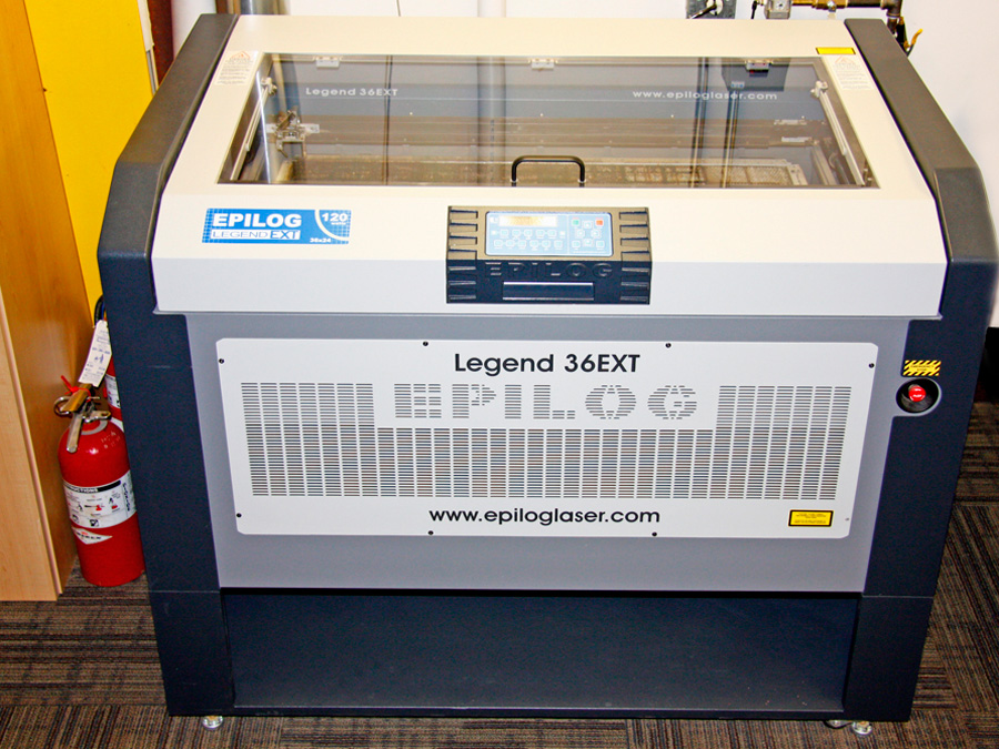 Epilogue Legend EXT Laser: This is a 2' x 3' dual head 120 watt laser. This machine provides acrylic cuts that are cleaner than flame polishing without the extra work. It can cut woods, plastics, solid surface, rubber, leather and much more. It can burn wood to create a look as if the part has been branded or burnt. In addition it can etch metals, glass, marble, even stainless steel.