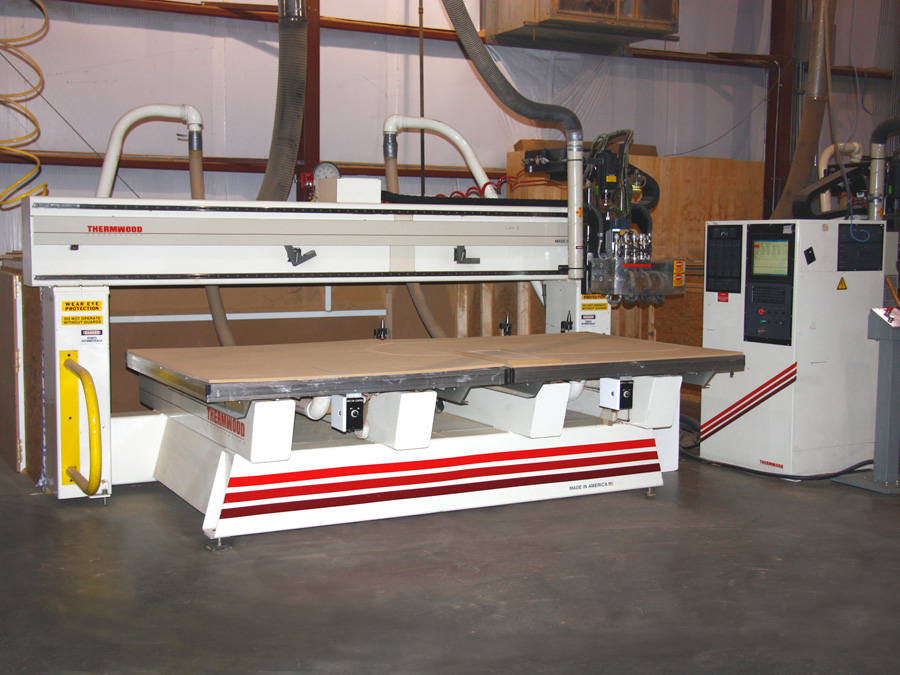 Thermwood Model 42 CNC Router: This is a 5' x 10' 4 axis router with twin 5' x 5' beds to allow for continuous production. One bed is always active while the other is being loaded and unloaded. It has a 5 position, head mounted typewriter tool changer designed for extremely fast tool changes to insure maximum performance as well as a 4 position rear tool changer for larger shaper type tooling. This machine also utilizes an aggregate tool holder for horizontal boring, sawing and profiling for v-groove and bead board panels.